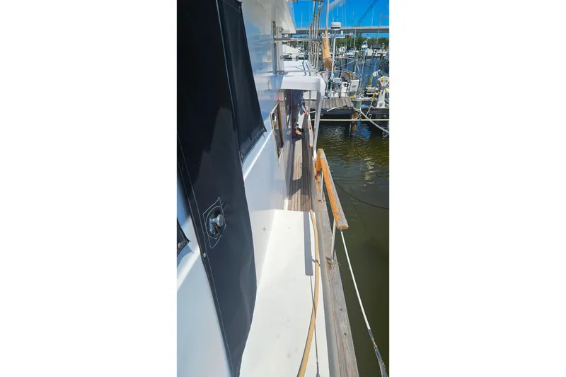 Slide: The Image of Side view of 1981 Sea Ranger 47 Pilothouse docked at marina. - 41
