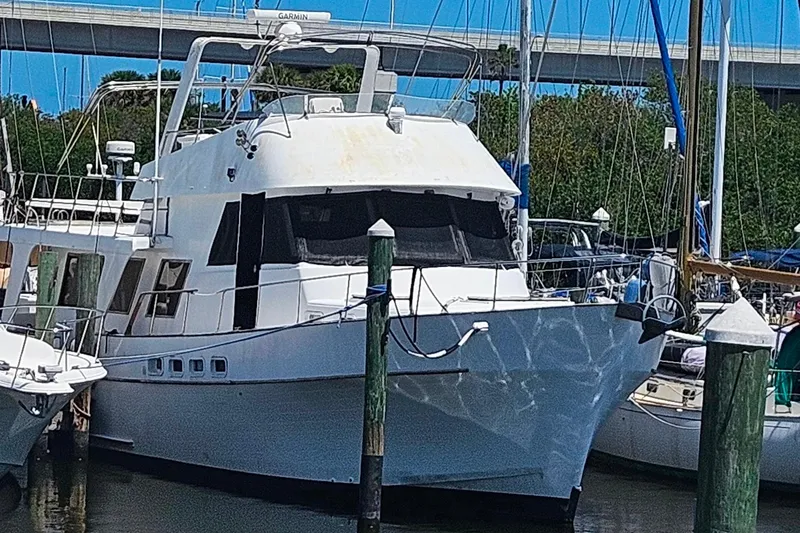 Slide: The Image of 1981 Sea Ranger 47 Pilothouse yacht docked at marina under clear blue sky. - 42
