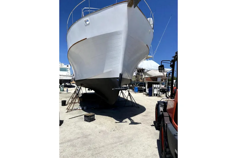 Slide: The Image of 1981 Sea Ranger 47 Pilothouse yacht on dry dock, undergoing maintenance. - 48