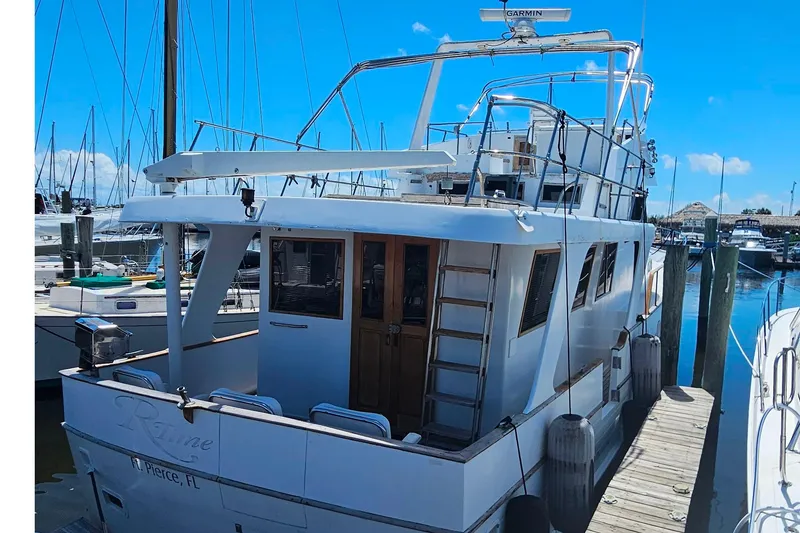 Slide: The Image of 1981 Sea Ranger 47 Pilothouse docked at marina under clear blue sky. - 5