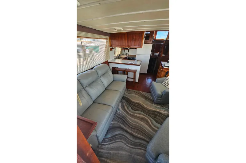 Slide: The Image of Interior of 1981 Sea Ranger 47 Pilothouse with cozy seating and kitchen area. - 6