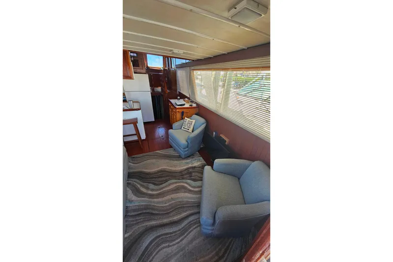 Slide: The Image of Interior of 1981 Sea Ranger 47 Pilothouse with cozy seating and nautical decor. - 7