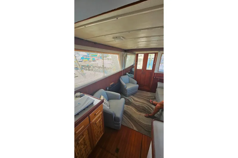 Slide: The Image of Interior of 1981 Sea Ranger 47 Pilothouse with cozy seating and wooden accents. - 8