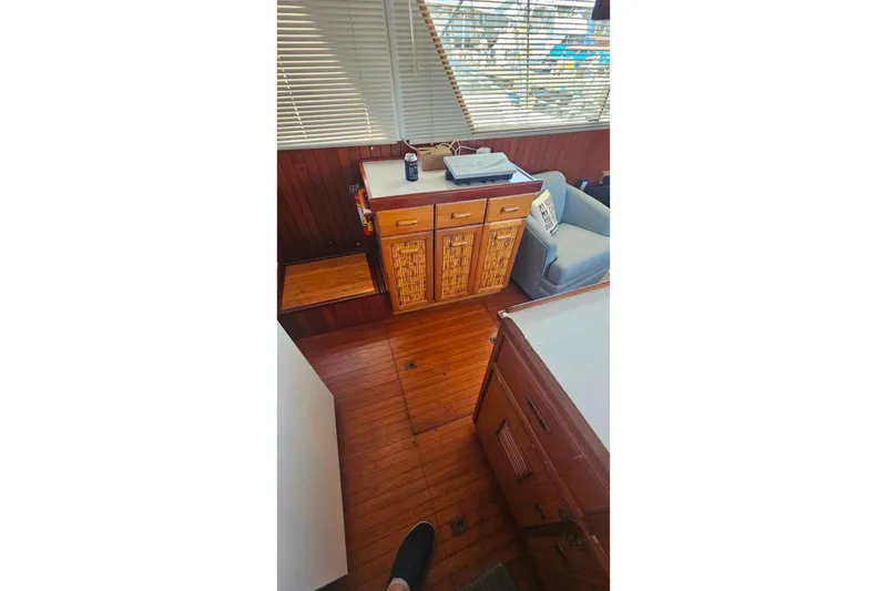 Slide: The Image of Interior of 1981 Sea Ranger 47 Pilothouse with wooden cabinetry and seating area. - 9