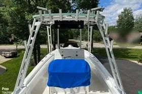 Slide: The Image of 1974 Boca Grande Passmaster 26 boat with blue cover, parked outdoors on a sunny day. - 10