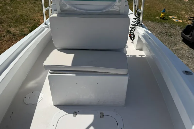 Slide: The Image of 1974 Boca Grande Passmaster 26 boat interior with white seating and storage compartment. - 12