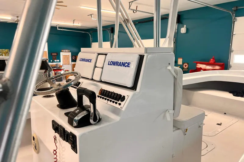 Slide: The Image of 1974 Boca Grande Passmaster 26 boat console with Lowrance electronics in a teal-walled garage. - 19