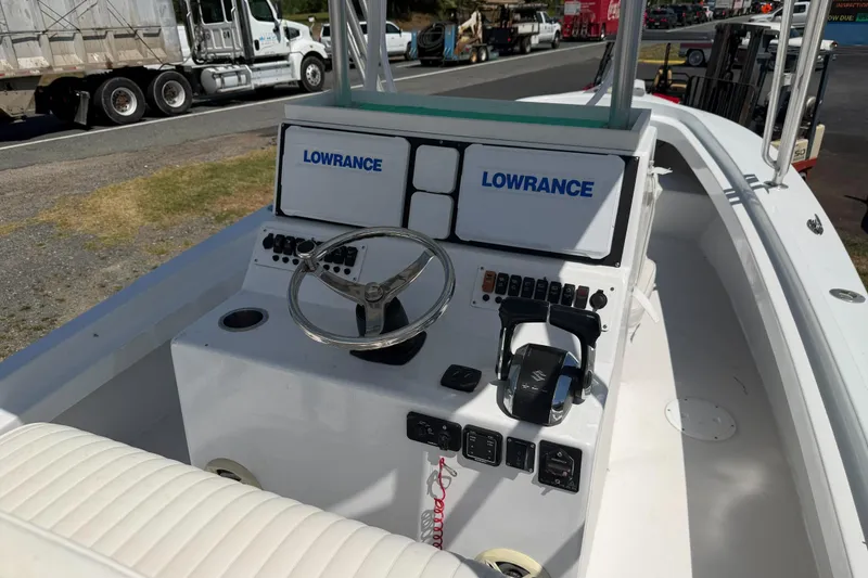 Slide: The Image of 1974 Boca Grande Passmaster 26 boat cockpit with Lowrance navigation system and steering wheel. - 20