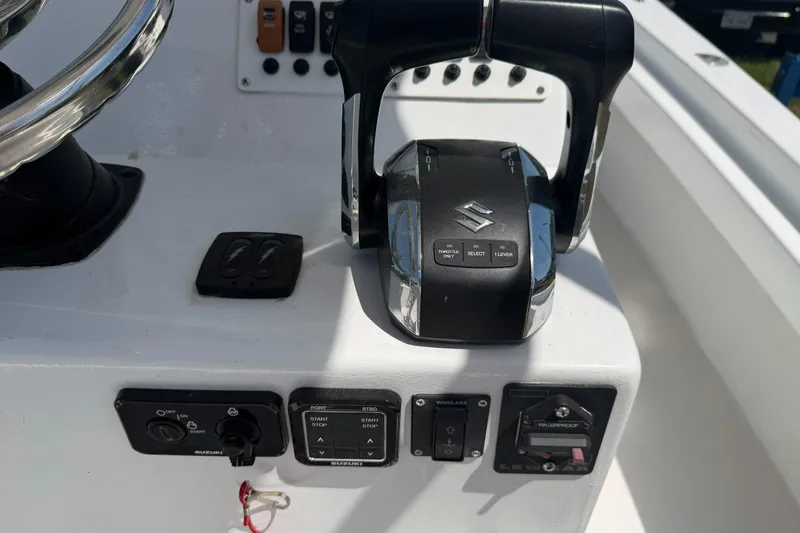 Slide: The Image of 1974 Boca Grande Passmaster 26 boat controls with Suzuki throttle and steering wheel. - 23
