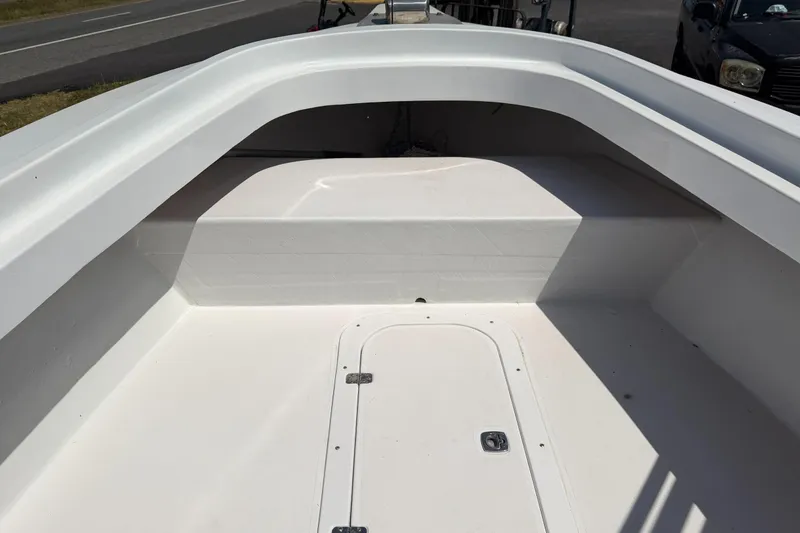 Slide: The Image of 1974 Boca Grande Passmaster 26 boat interior with white seating and storage compartment. - 26