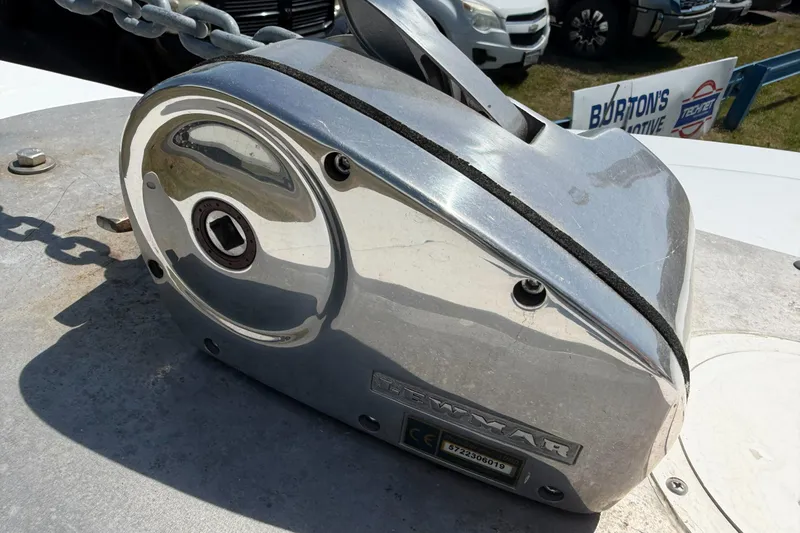 Slide: The Image of Chrome anchor windlass on a 1974 Boca Grande Passmaster 26 boat deck. - 27