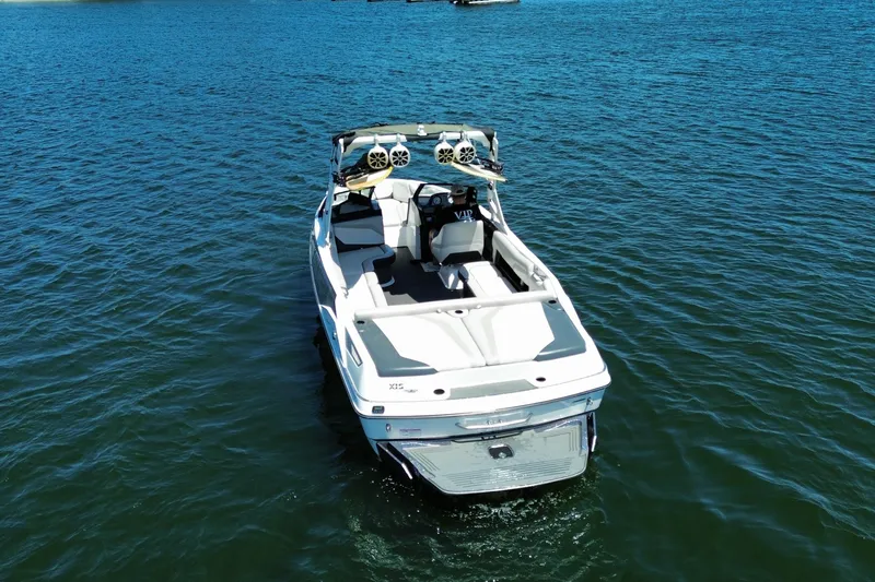 Slide: The Image of 2017 Axis T23 boat on calm blue water, showcasing sleek design and spacious seating. - 10