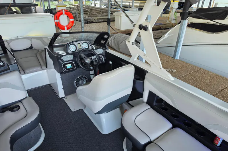 Slide: The Image of 2017 Axis T23 boat interior with steering console and seating area. - 15