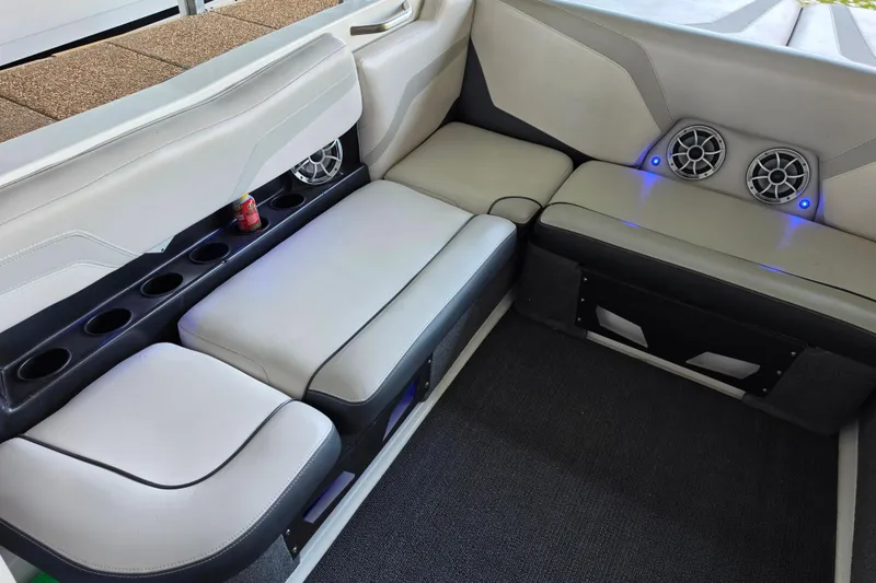 Slide: The Image of Interior of a 2017 Axis T23 boat with cushioned seating and built-in speakers. - 18