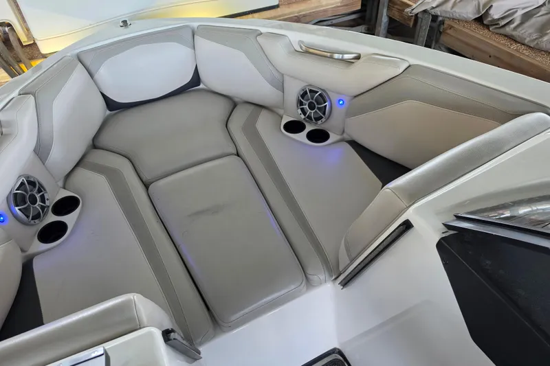 Slide: The Image of Interior of a 2017 Axis T23 boat with cushioned seating and built-in speakers. - 20