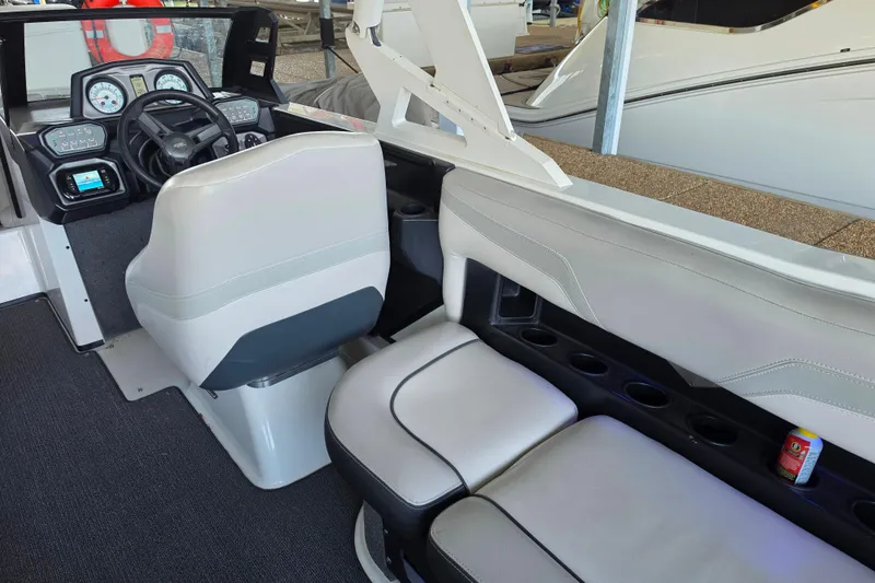 Slide: The Image of Interior of a 2017 Axis T23 boat featuring steering console and seating area. - 22
