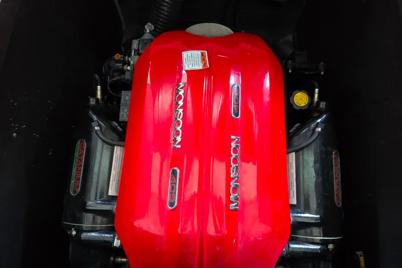 Slide: The Image of 2017 Axis T23 boat engine with red Monsoon 409 cover, showcasing Catanium components. - 25