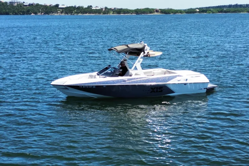Slide: The Image of 2017 Axis T23 boat on a calm lake with scenic background. - 7