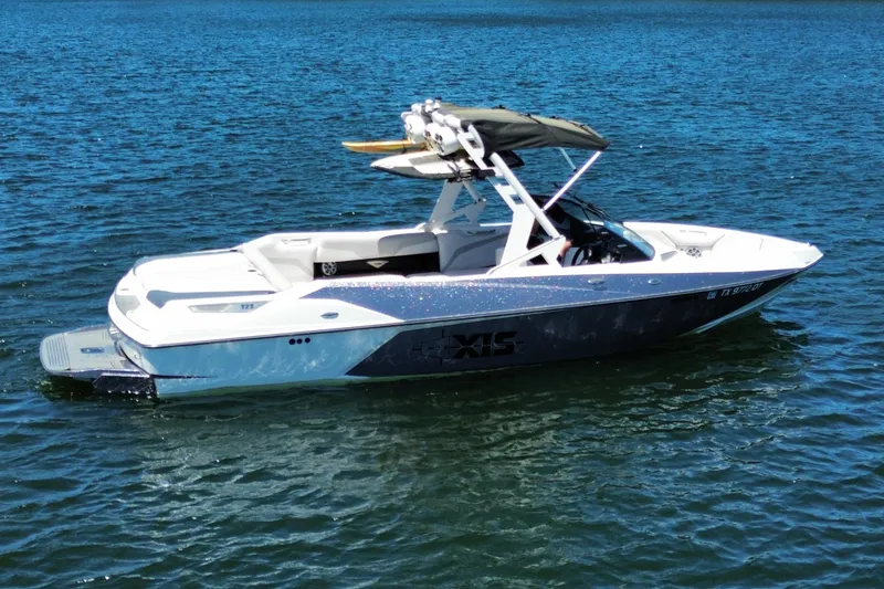 Slide: The Image of 2017 Axis T23 boat on water, featuring sleek design and wakeboard tower. - 9
