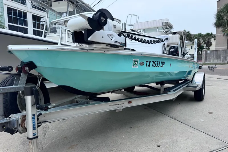 The Image of 2016 East Cape Fury boat on trailer, light blue hull, parked outdoors. - 0