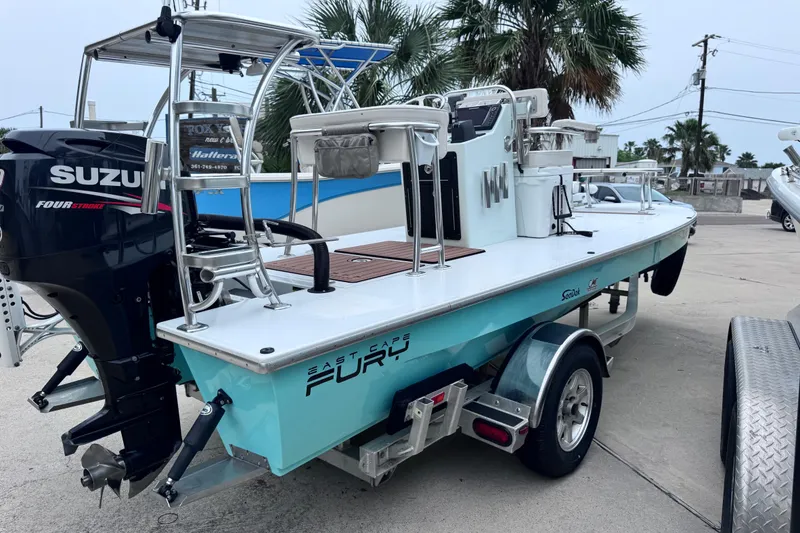 Slide: The Image of 2016 East Cape Fury boat with Suzuki engine on trailer, parked outdoors. - 10