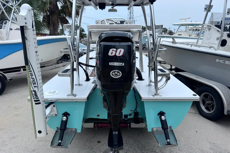 Slide: The Image of 2016 East Cape Fury boat with 60 HP engine, docked among other boats. - 11