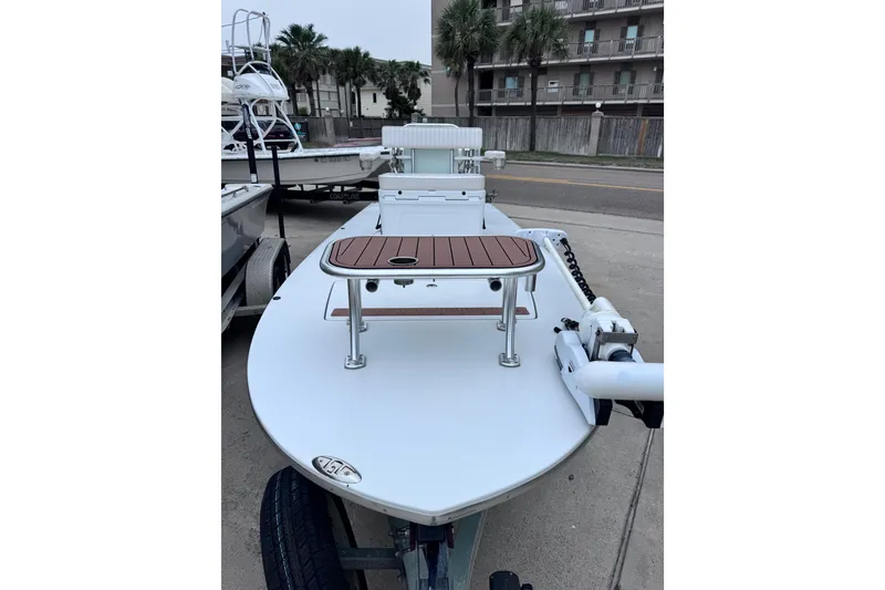 Slide: The Image of 2016 East Cape Fury boat with wooden deck, parked on a trailer. - 12