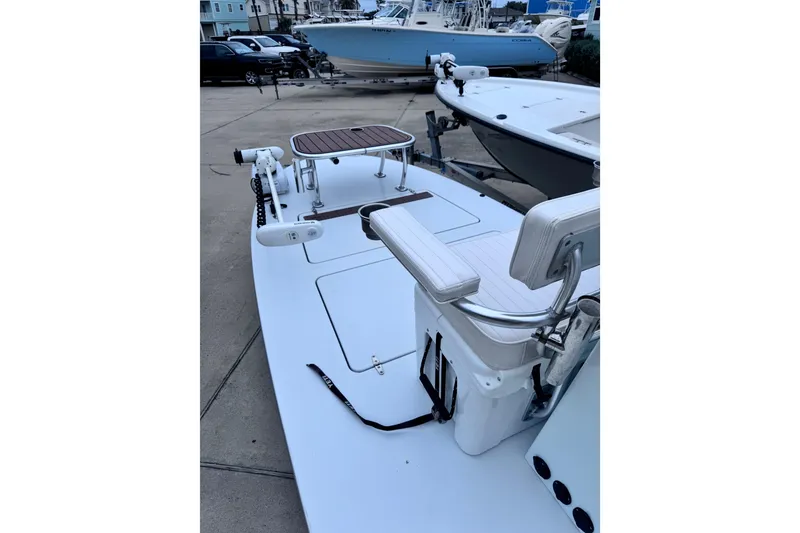 Slide: The Image of 2016 East Cape Fury boat with seating and equipment, docked in a marina. - 14