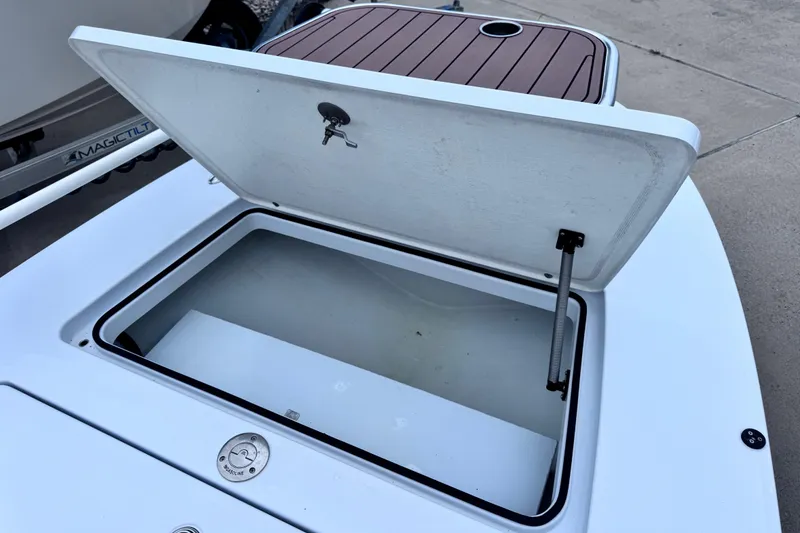 Slide: The Image of Open storage compartment on a 2016 East Cape Fury boat, showcasing interior space. - 18