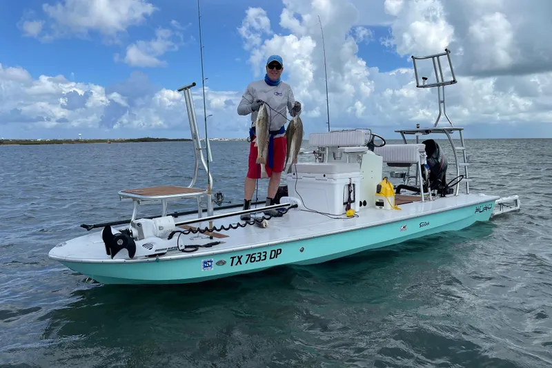 Slide: The Image of Man holding fish on 2016 East Cape Fury boat in open water. - 2