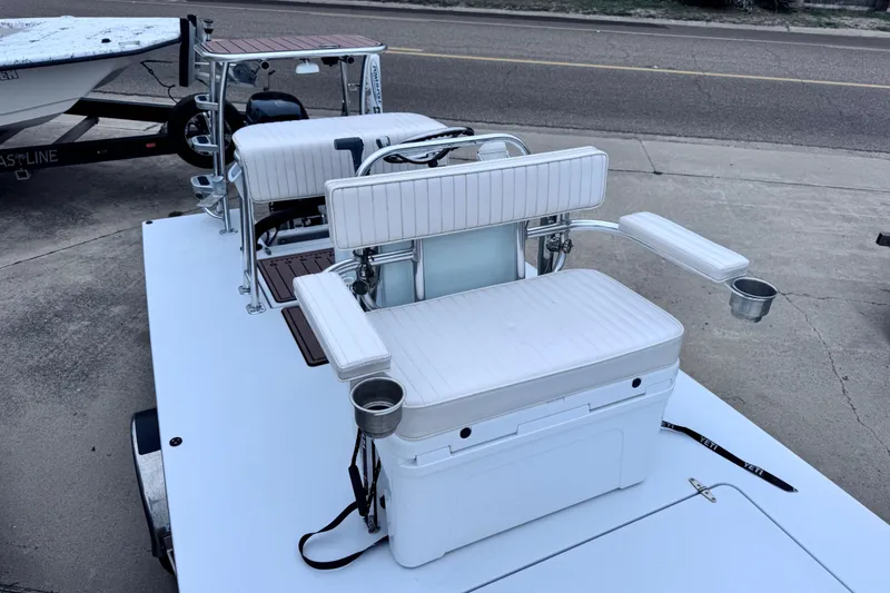 Slide: The Image of 2016 East Cape Fury boat with white seating and cup holders on a trailer. - 20