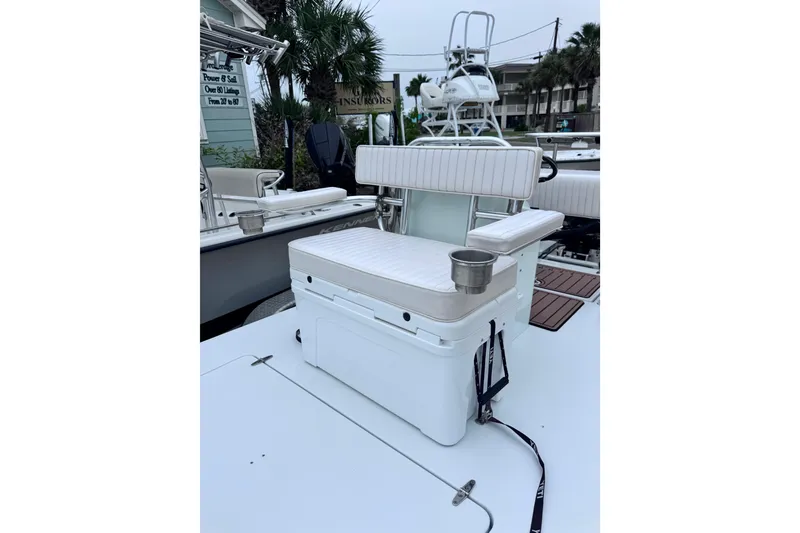 Slide: The Image of 2016 East Cape Fury boat with cushioned seating and cup holder on deck. - 21