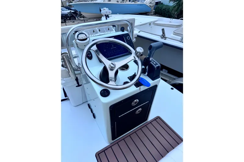Slide: The Image of 2016 East Cape Fury boat console with steering wheel and controls. - 22