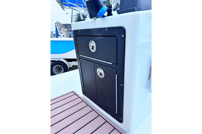 Slide: The Image of 2016 East Cape Fury boat console with storage compartments and teak flooring. - 25