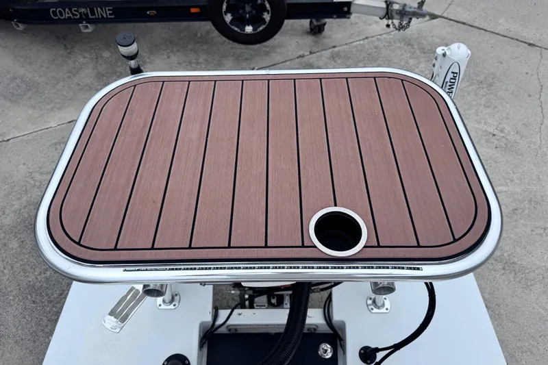 Slide: The Image of 2016 East Cape Fury boat deck with wood finish and cup holder. - 31