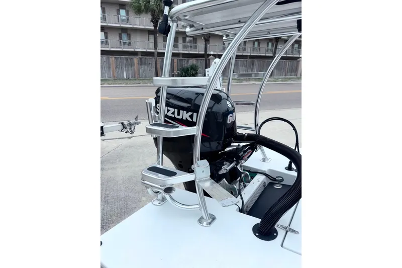 Slide: The Image of 2016 East Cape Fury boat with Suzuki 60HP outboard motor, docked near a building. - 33