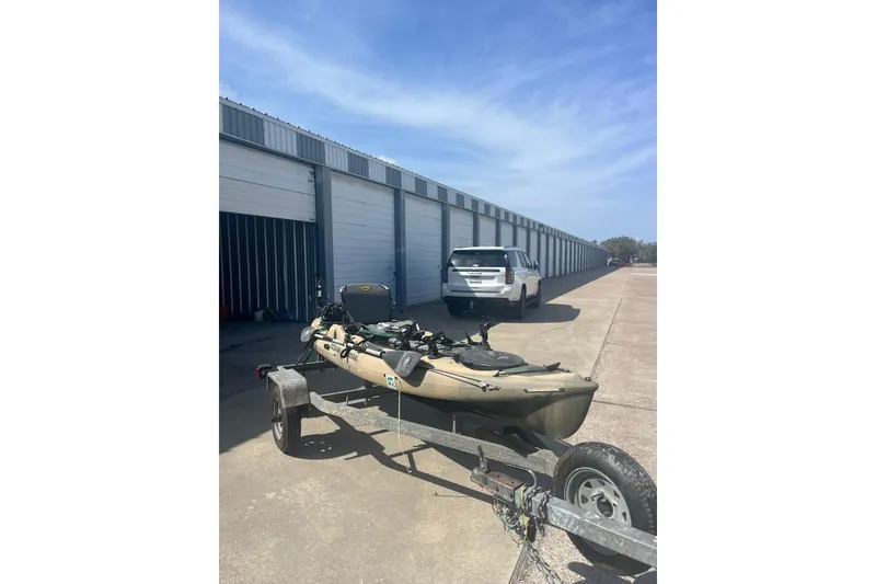Slide: The Image of 2016 East Cape Fury boat on trailer near storage units under blue sky. - 38