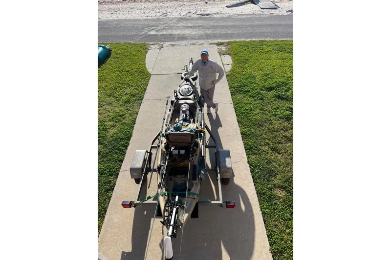 Slide: The Image of Man standing beside 2016 East Cape Fury boat on trailer, sunny day. - 43