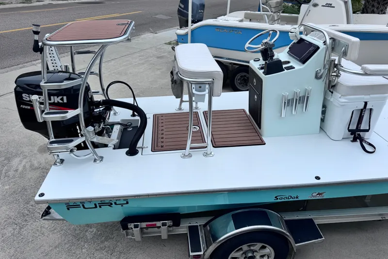 Slide: The Image of 2016 East Cape Fury boat with Suzuki engine, featuring a sleek deck and modern controls. - 5