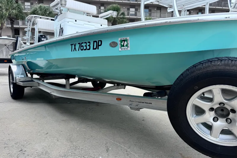 Slide: The Image of 2016 East Cape Fury boat on trailer, turquoise hull, registration TX 7633 DP. - 6