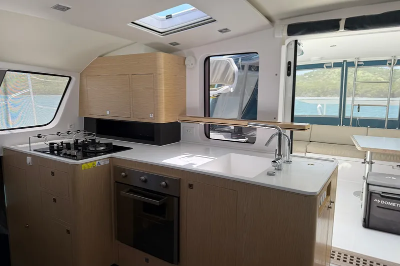 Slide: The Image of Modern kitchen interior of 2022 Outremer 51 yacht with sleek design and ocean view. - 14