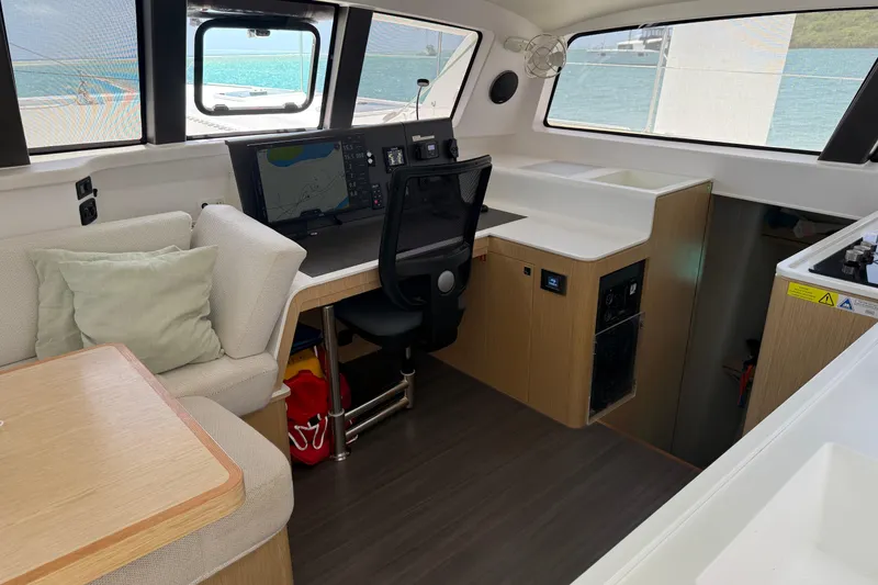 Slide: The Image of Interior of 2022 Outremer 51 yacht with navigation station and seating area. - 16