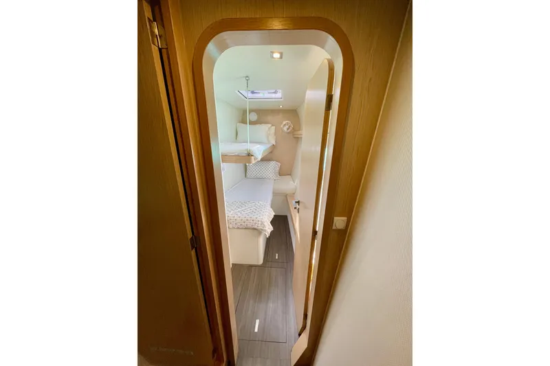 Slide: The Image of Interior cabin of 2022 Outremer 51 yacht, featuring cozy bedding and modern design. - 18