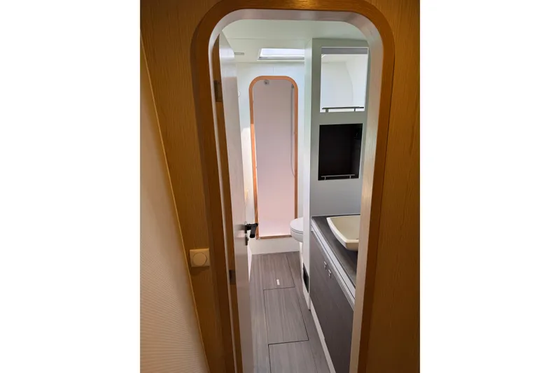 Slide: The Image of Interior view of 2022 Outremer 51 yacht bathroom, featuring modern design and fixtures. - 21