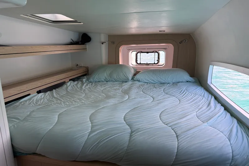 Slide: The Image of Cozy cabin interior of 2022 Outremer 51 yacht with comfortable bed and ocean view. - 23