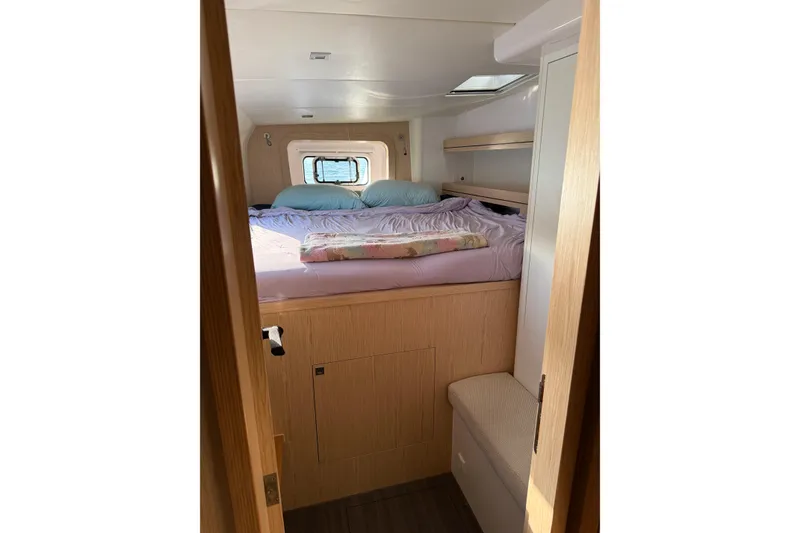 Slide: The Image of Interior cabin of 2022 Outremer 51 yacht with cozy bed and window view. - 24