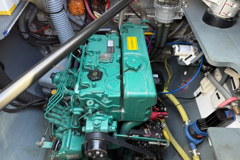Slide: The Image of Engine compartment of a 2022 Outremer 51, showcasing a green marine engine. - 25