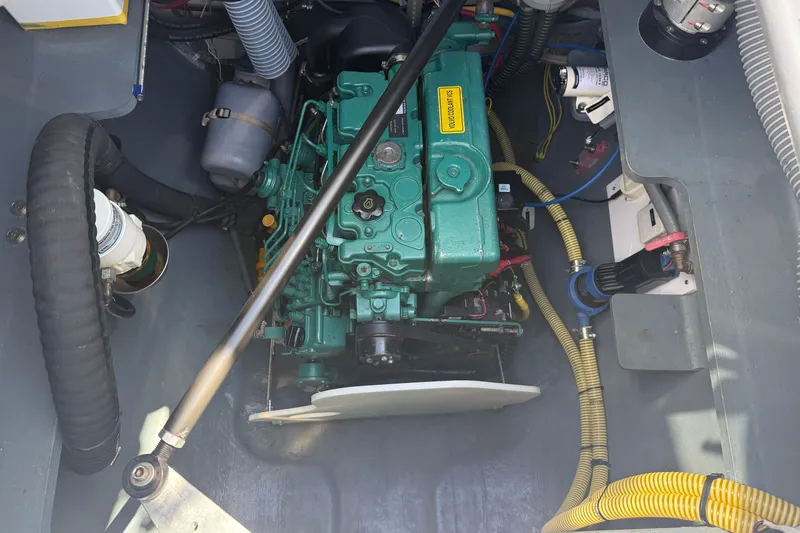 Slide: The Image of Engine compartment of a 2022 Outremer 51 catamaran, featuring a green marine engine. - 26