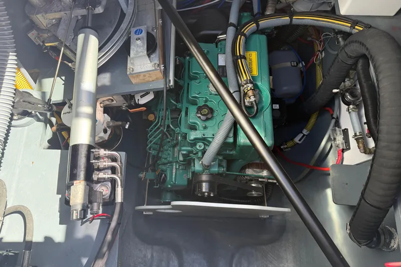 Slide: The Image of Engine compartment of a 2022 Outremer 51 catamaran, showcasing mechanical components and wiring. - 27