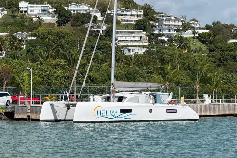 Slide: The Image of Outremer 51 catamaran docked by lush hillside, 2022 model. - 28